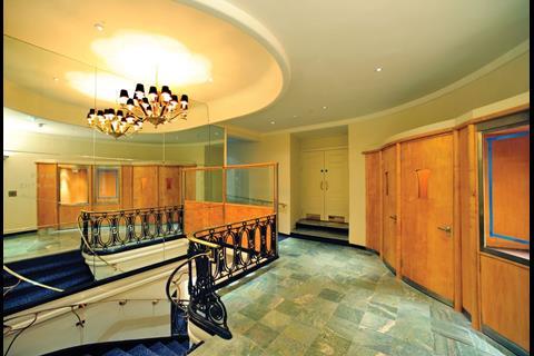 A lobby shows the original green marble flooring and art deco woodwork